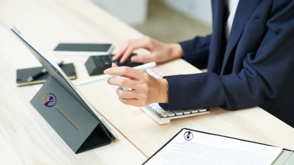 A training provider reviewing a digital quality assurance checklist on a laptop, ensuring compliance with national and international accreditation standards.